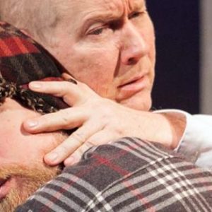 man comforts another man
