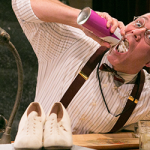 man squirting whipped cream into his mouth