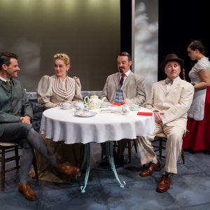 dining scene with three men and a woman