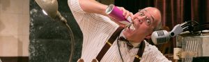 man squirting whipped cream in his mouth